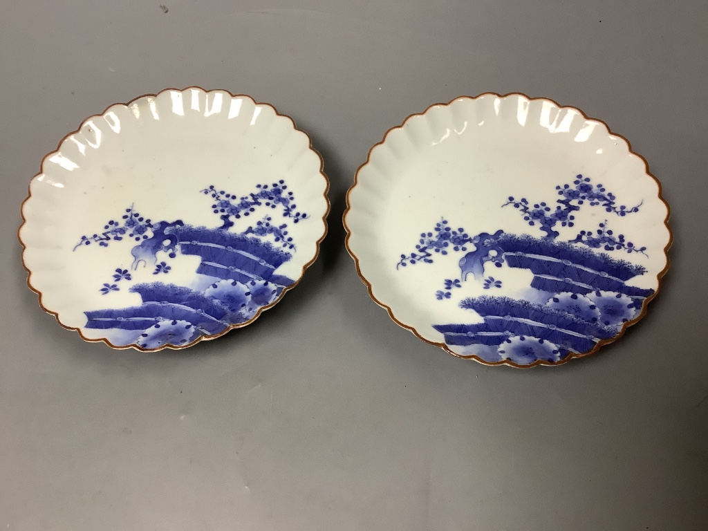 A pair of Japanese Kakiemon blue and white dishes, late 17th century, diameter 15cm, Spink & Son label